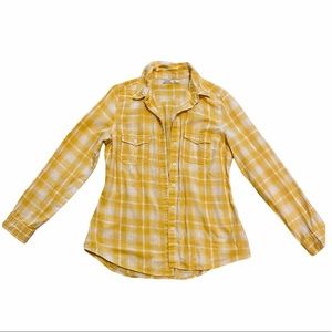 Yellow button down shirt.
